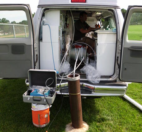 USGS scientist sampling groundwater from a well for contaminants of emerging concern, Minnesota.