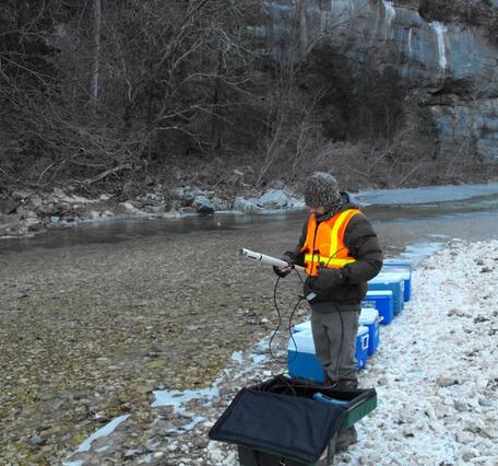 Scientist collects water samples and measurement at North Sylamore Cr