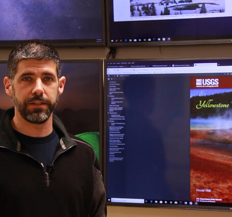 Man standing in front of TV