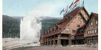 Historic colorized photograph of Old Faithful geyser and Old Faithful Inn