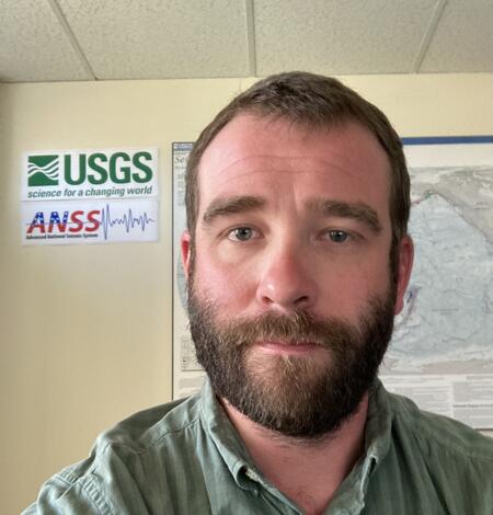 headshot of person with USGS logo in the background