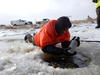 Scientist collecting stream water through ice in Blacktail Creek, North Dakota downstream of a oil and gas wastewater spill.