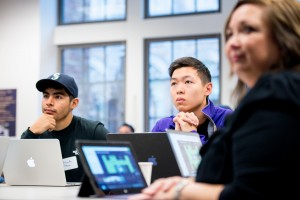 Students coding in classroom with UW President, Ana Mari Cauce