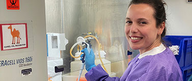 Researcher Stephanie Goya wearing purple scrubs.