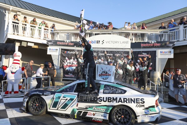 Chris Buescher (17) celebrates winning a NASCAR Cup Series auto race, Sunday, Sept. 15, 2024, in Watkins Glen, N.Y. (AP Photo/Lauren Petracca)