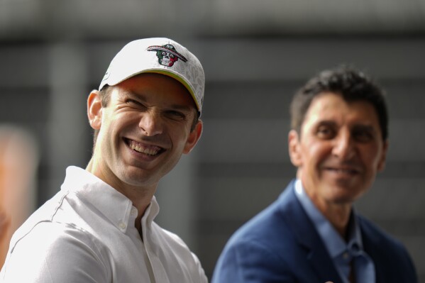 NASCAR driver Daniel Suarez, of Mexico, smiles alongside NASCAR Mexico Series CEO and President Jimmy Morales, during a press conference in Mexico City, Tuesday, Aug. 27, 2024. (AP Photo/Eduardo Verdugo)