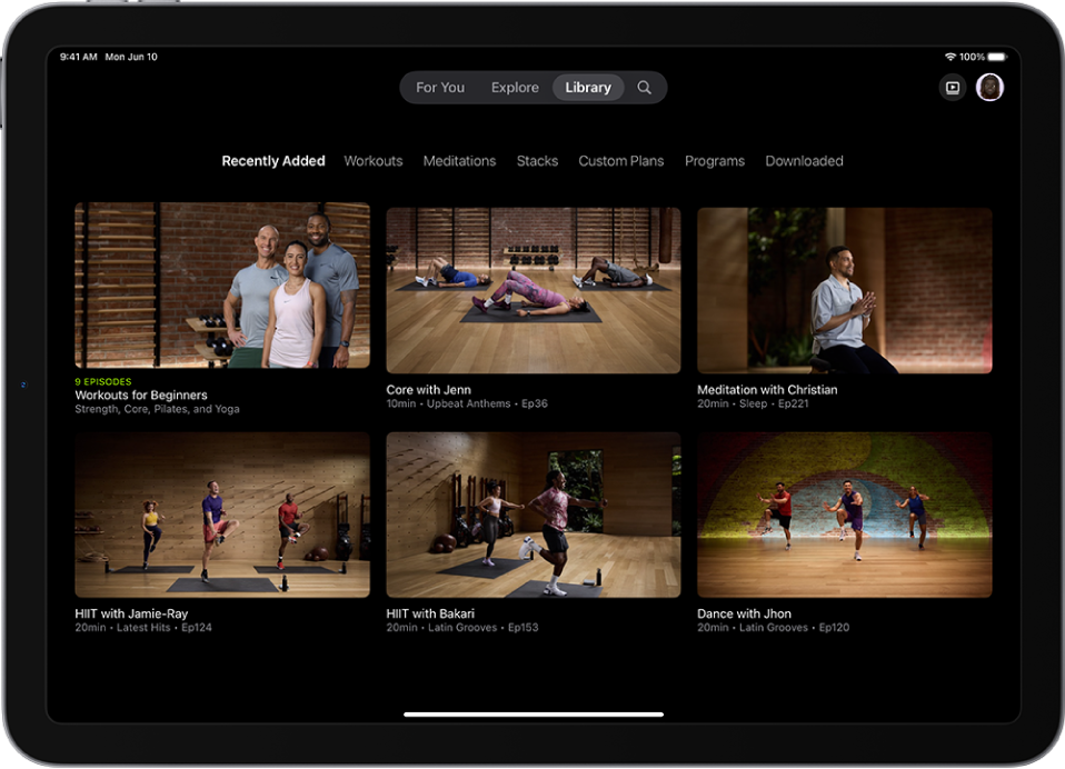 The Library screen in Apple Fitness+ showing a workout program, four workouts, and a meditation. A row of categories is at the top of the screen.