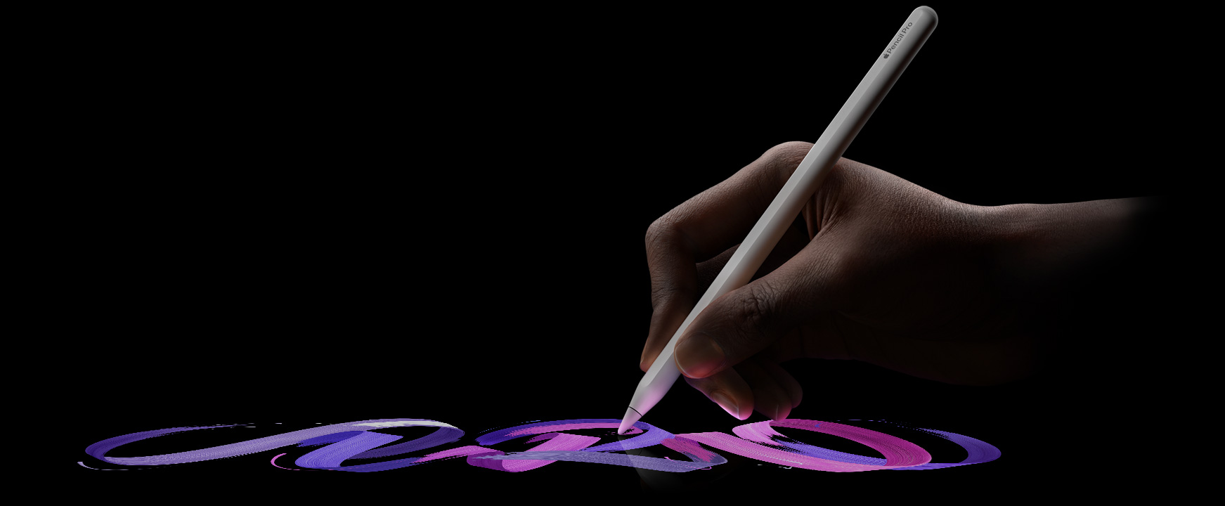 ユーザーがApple Pencil Proを持ち、色あざやかなブラシの線を描いている。
