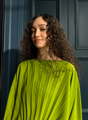 A photo shot in 35mm of a woman in a green dress