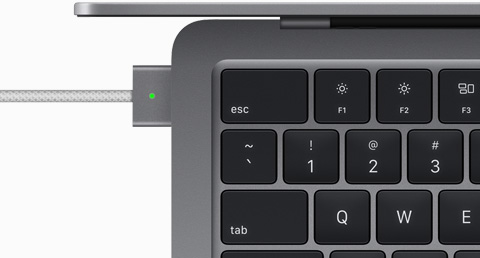 Top view showing MagSafe cable plugged into MacBook Air in Space Gray color