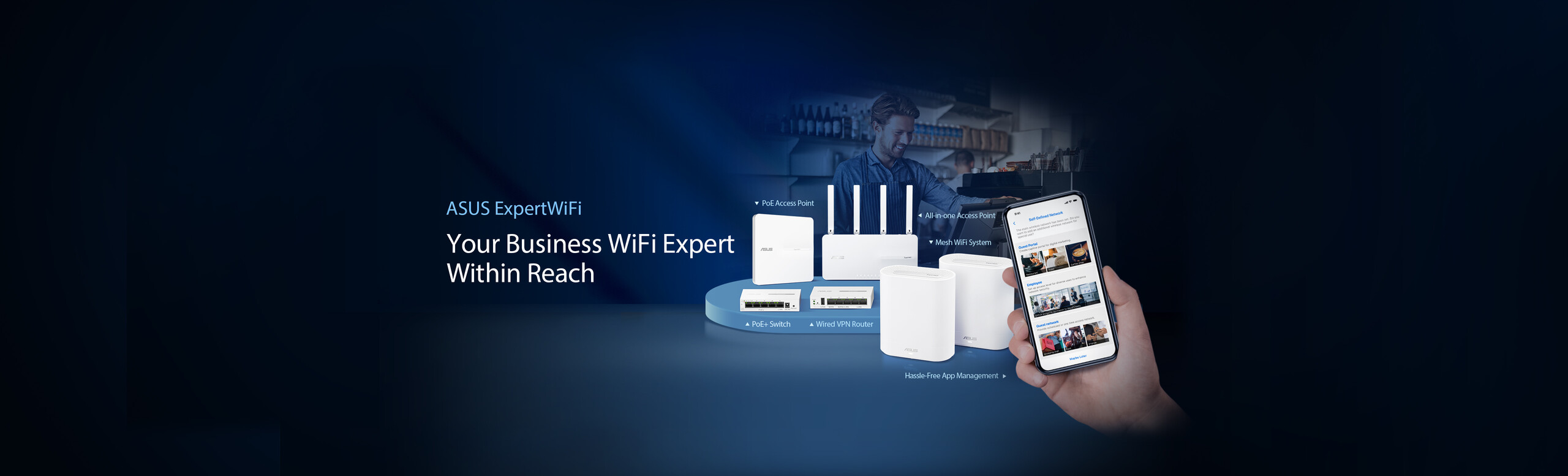 ASUS ExpertWiFi lineup in café setting with a hand holding phone showing the ExpertWiFi app UI. Rear row from left: EBA63 PoE AP, EBR63 all-in-one AP. Front: EBP15 POE+ switch, EBG15 wired VPN router, and two EBM68 mesh WiFi system.