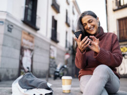 A picture of a woman smiling and looking at her phone