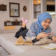 A student in a headscarf looks at her phone