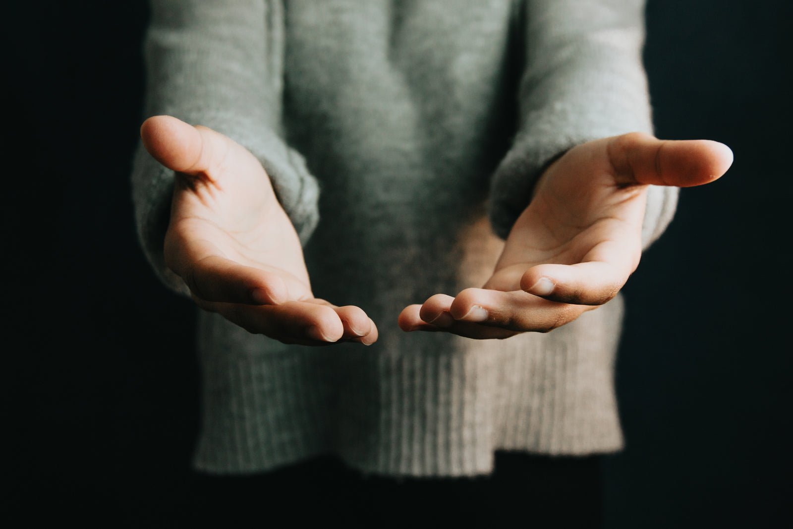 Person holding their hands towards the camera