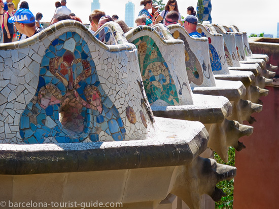 Antoni Gaudí Güell Park - mosaic seating area adorned with multi-coloured tiles