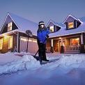 woman shoveling snow off driveway