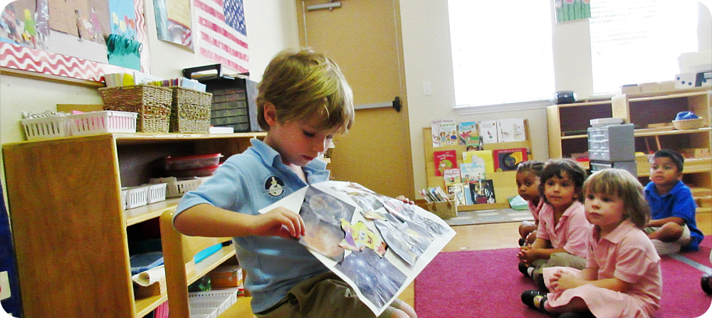 little boy showing his work to the class