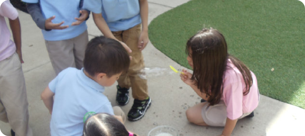 kids playing bubbles in the park