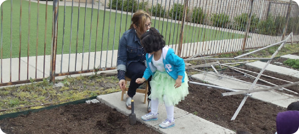 teacher showing the kids how to plant