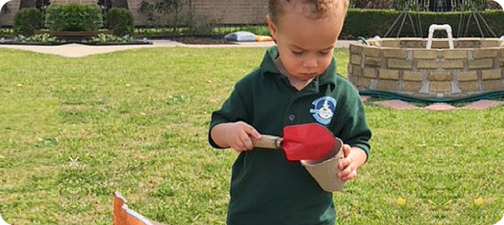 young boy handling a mini shovel