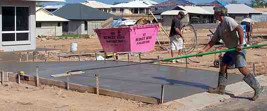 Using a bullfloat on a fresh concrete slab