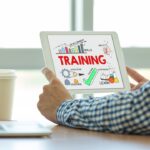 man reading a tablet with training written on it