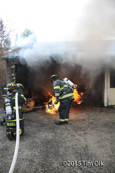 firemen fight garage fire