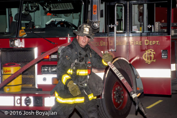 firefighter with hose at scene