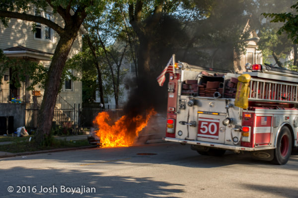 firefighters battle car fire