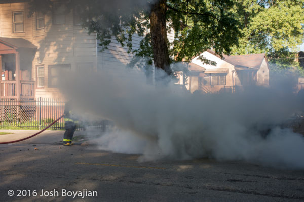 firefighters extinguish car fire