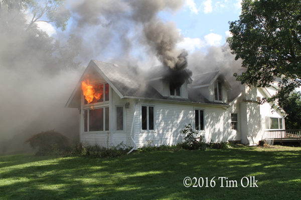 heavy smoke and flames from house fire