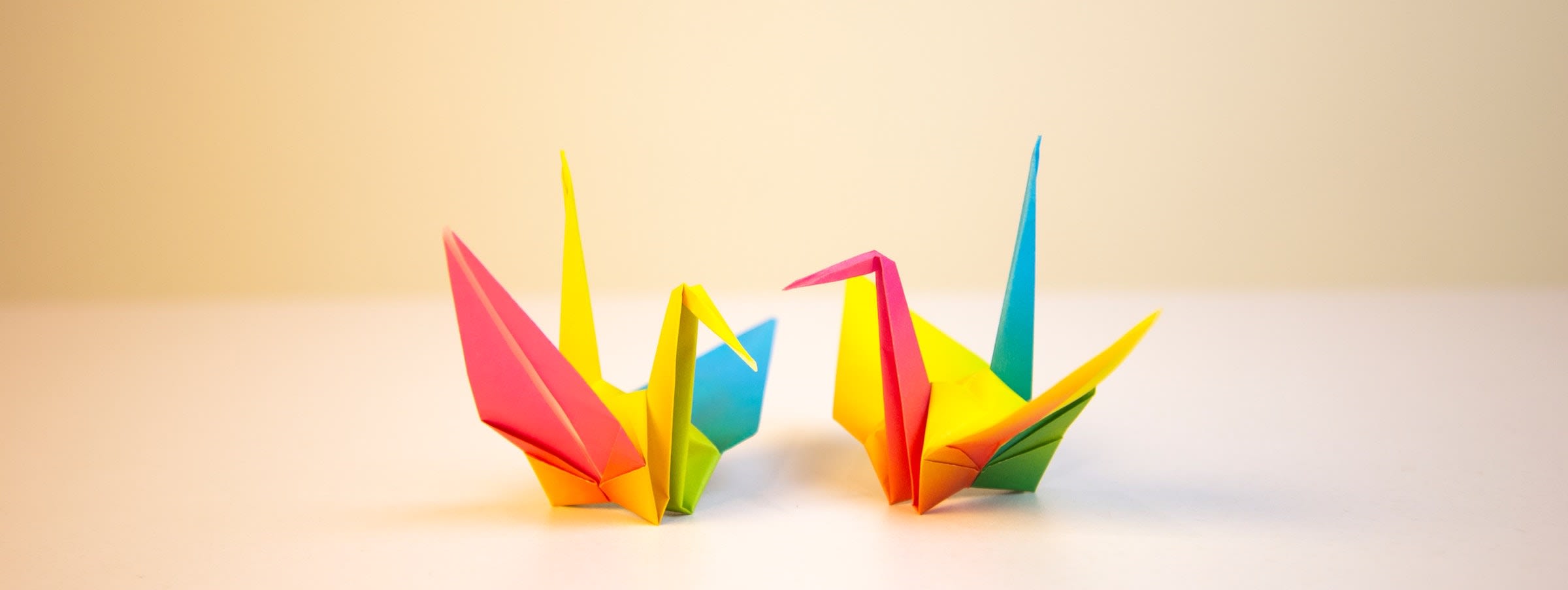 Two colorful origami cranes