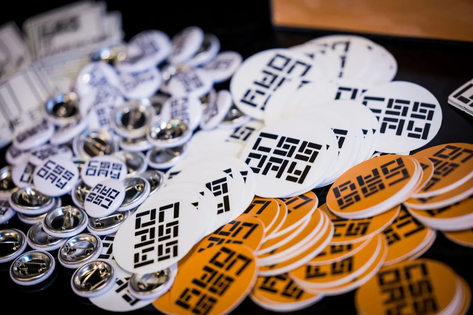 An upclose photo of ping and stickers with the CSS Day logo