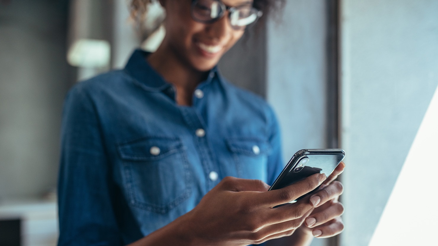 Smiling young woman checking her phone