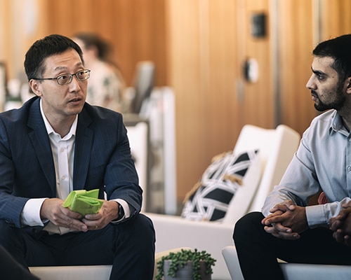 Two seated men having a discussion