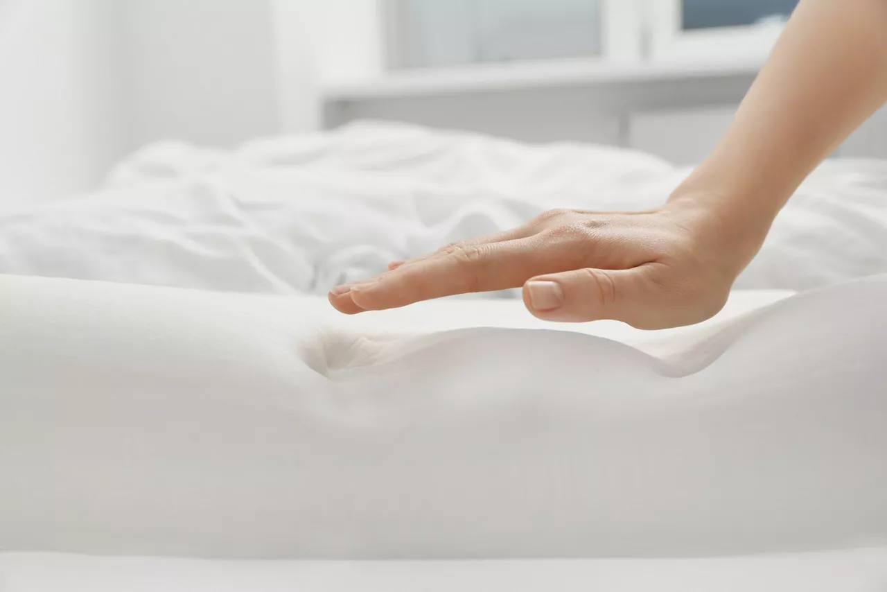 Woman with orthopedic memory foam pillow.