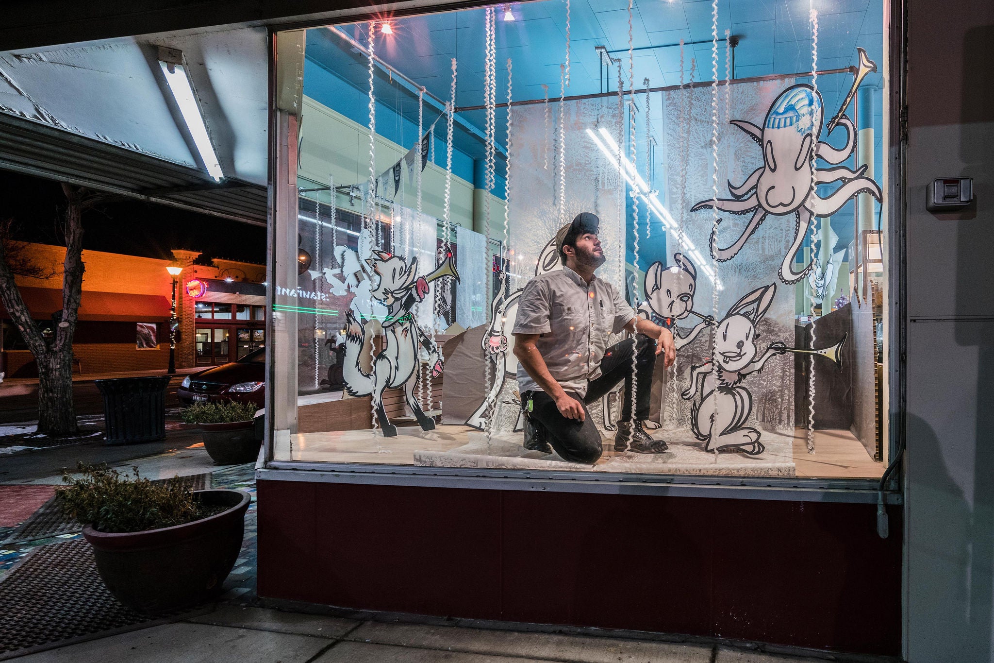 Man decorating display window in music store static