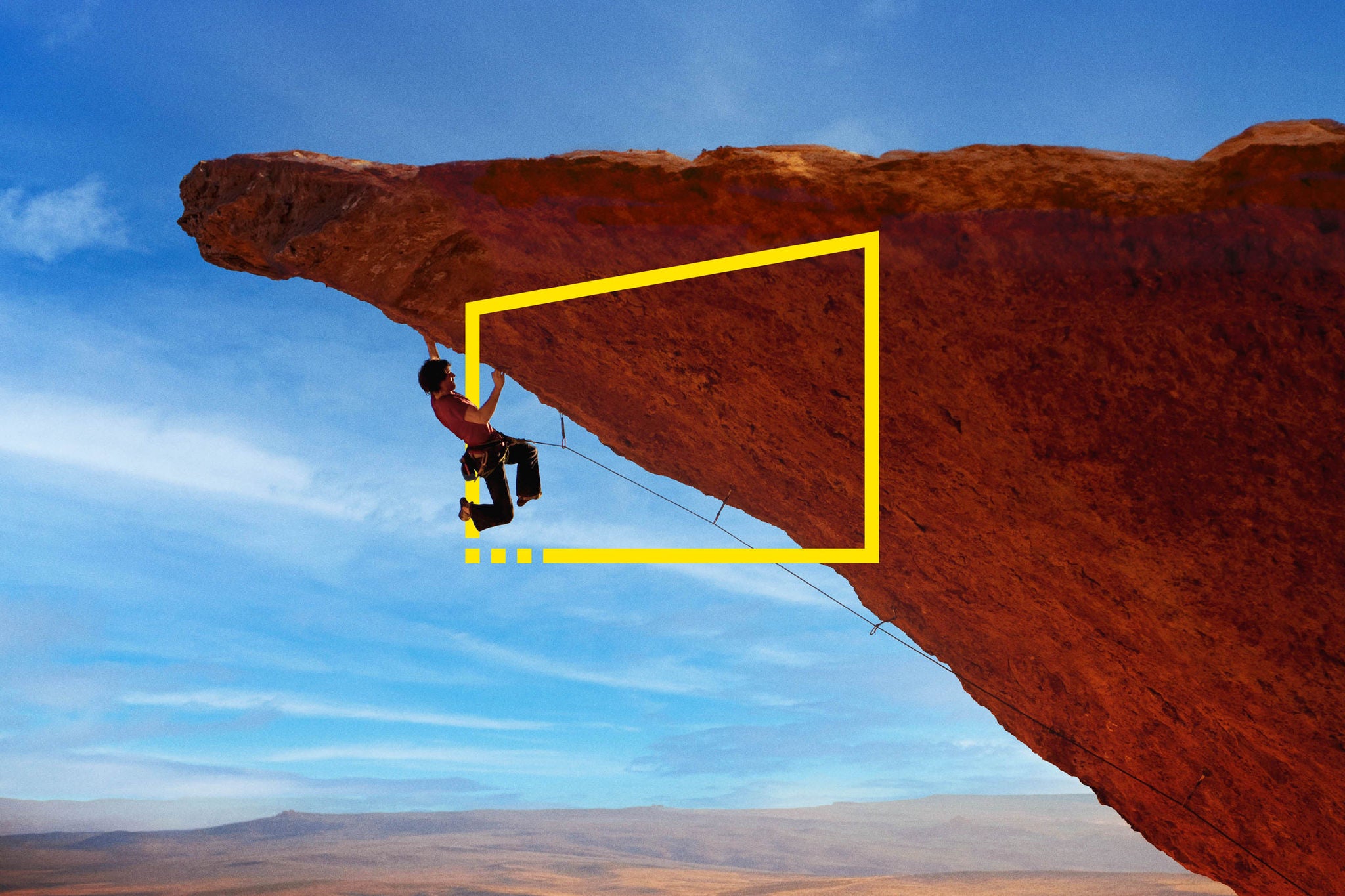 rock climber lunging for a hand hold rock wall in South West Utah