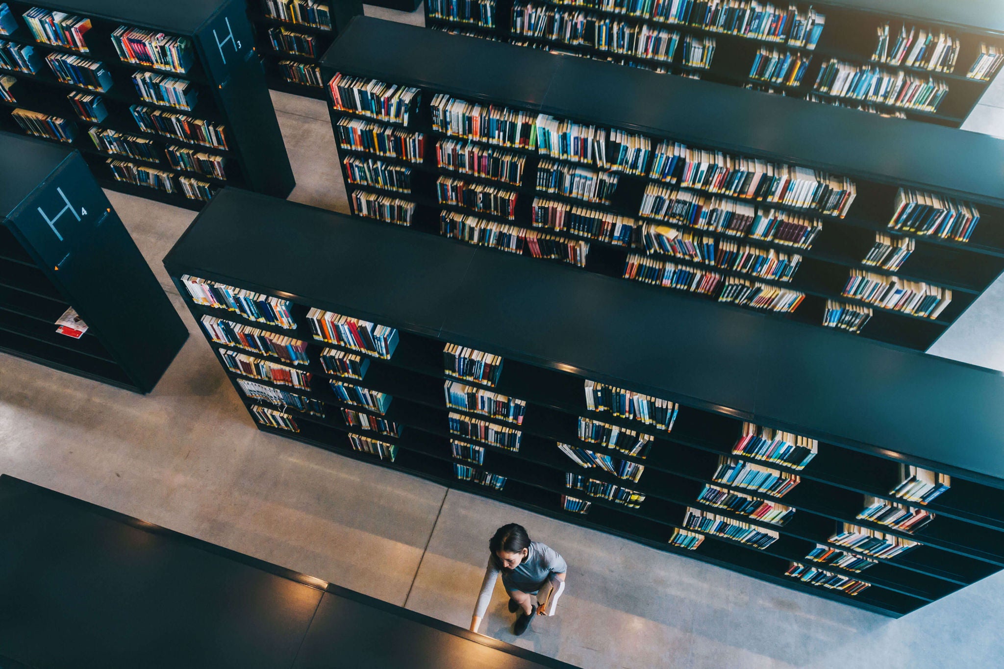 A woman browsing books at a library