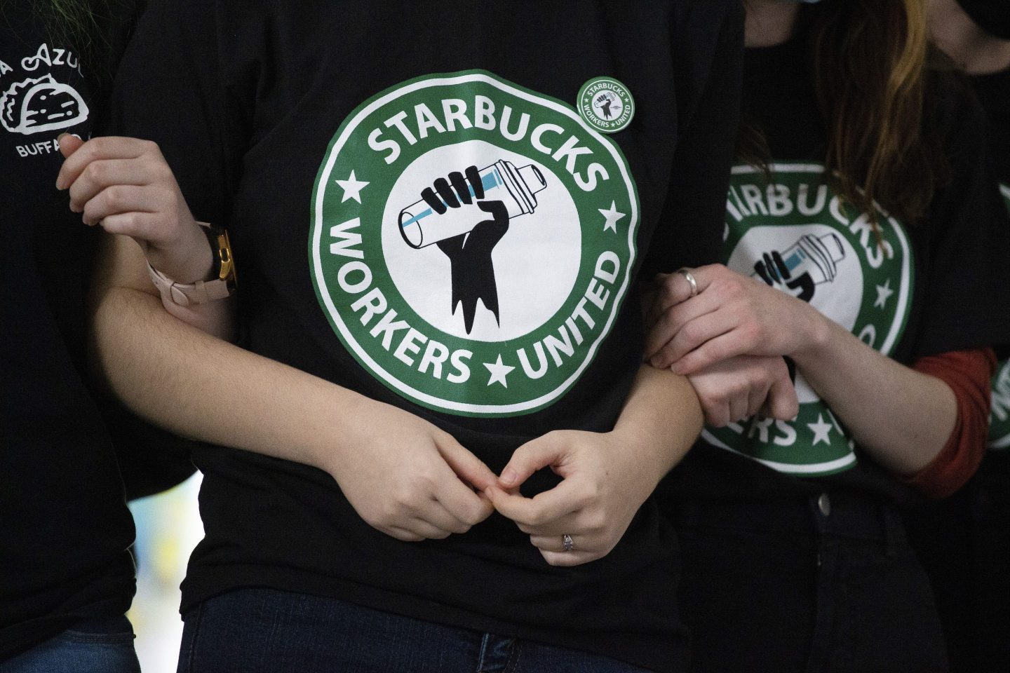 FILE &#8211; Starbucks employees and supporters link arms during a union election watch party Dec. 9, 2021, in Buffalo, N.Y. The U.S. Supreme Court is set to hear oral arguments in a case filed by Starbucks against the National Labor Relations Board. (AP Photo/Joshua Bessex, File)