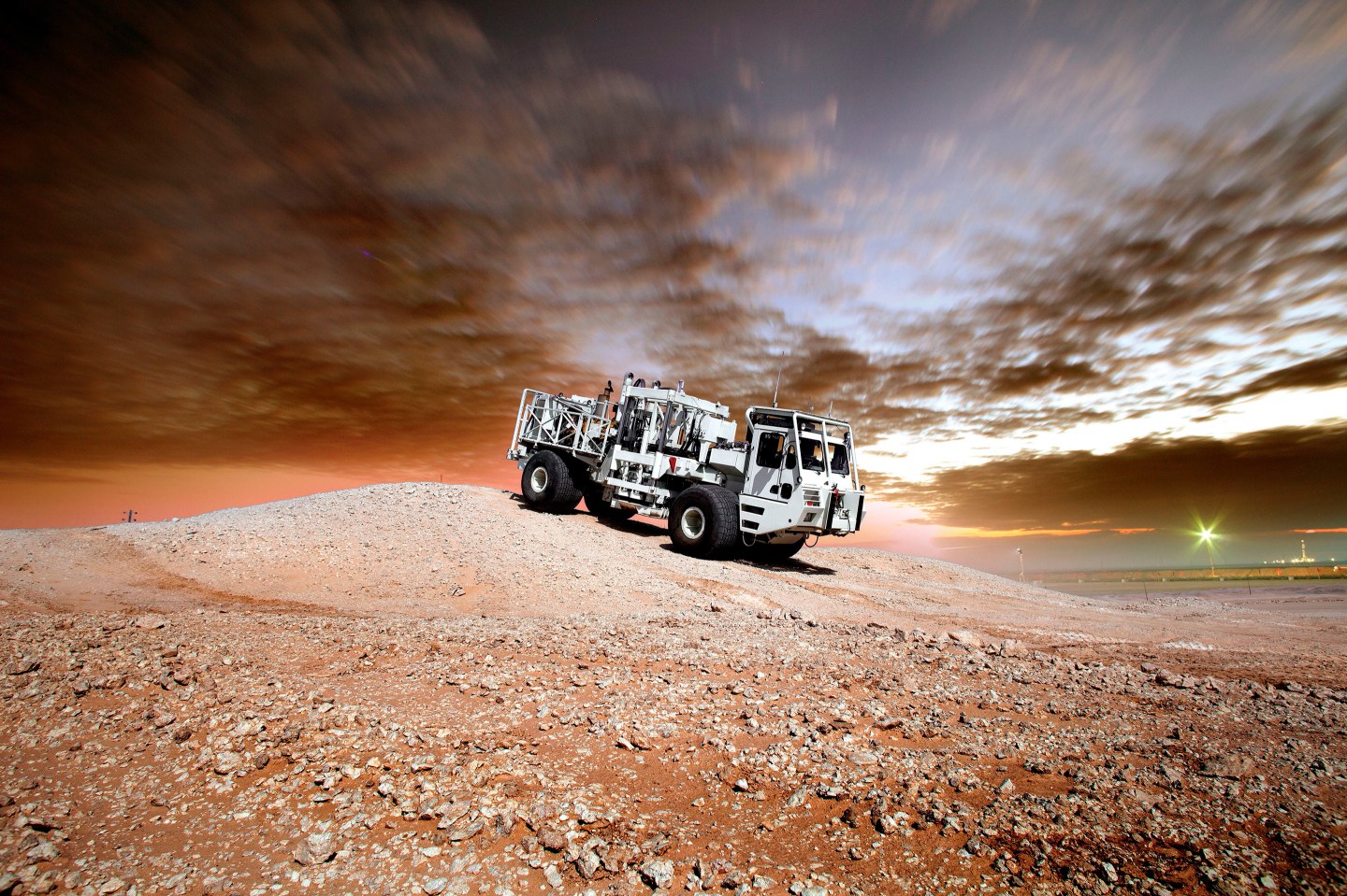 Image of Saudi Aramco's seismic robot in the desert, where they use AI to analyze geological formations deep underground.