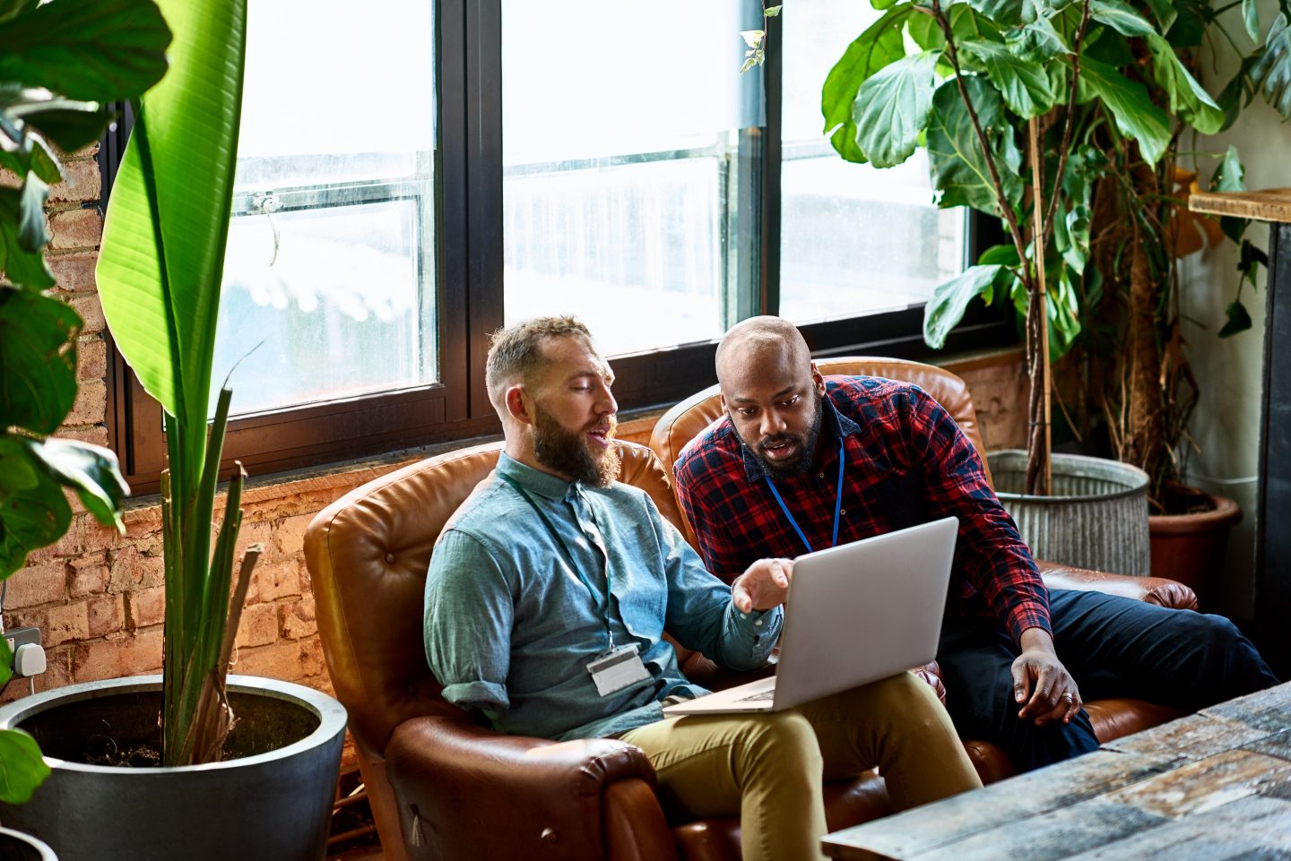 Workers collaborate at computer