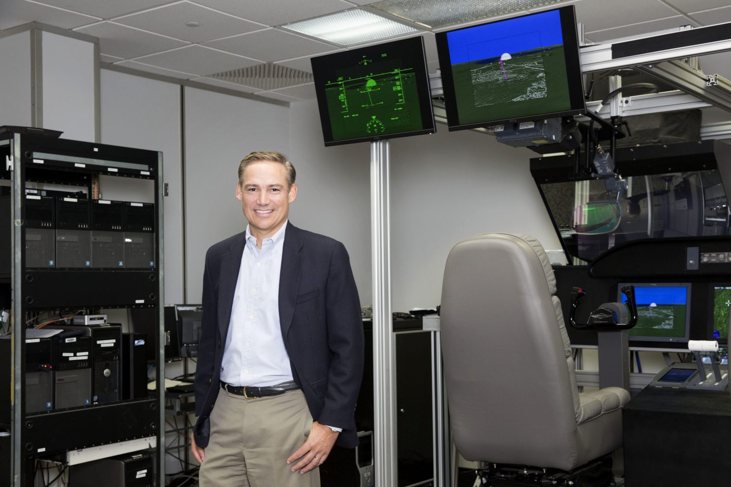 New Boeing CEO Kelly Ortberg standing in front of a system of monitors at the production facility of Rockwell Collins, where he was CEO, in 2016.