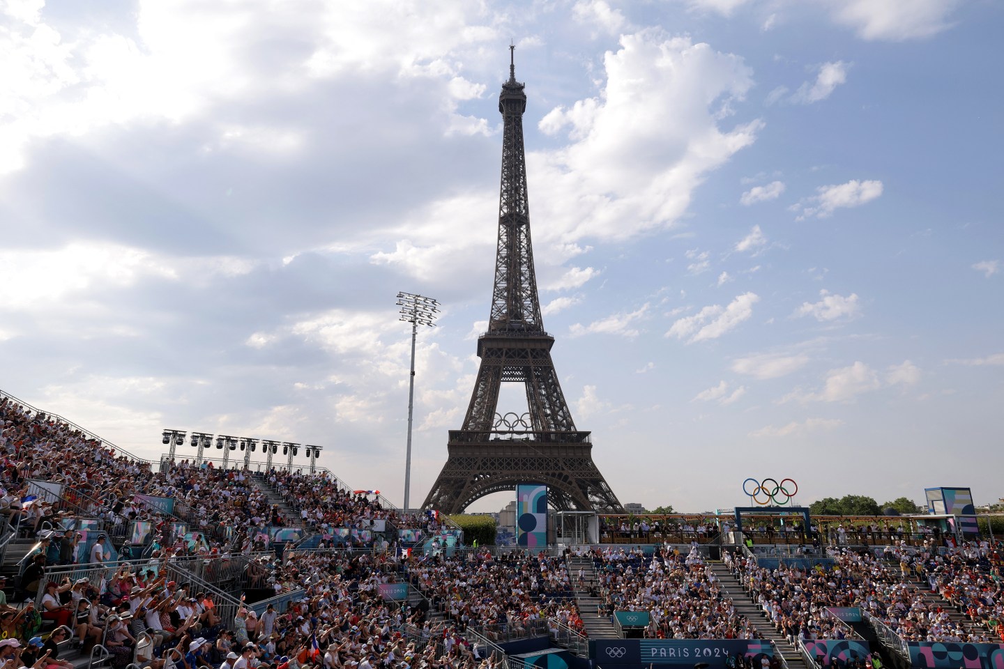 crowds of people with the Eiffel Tower at the back