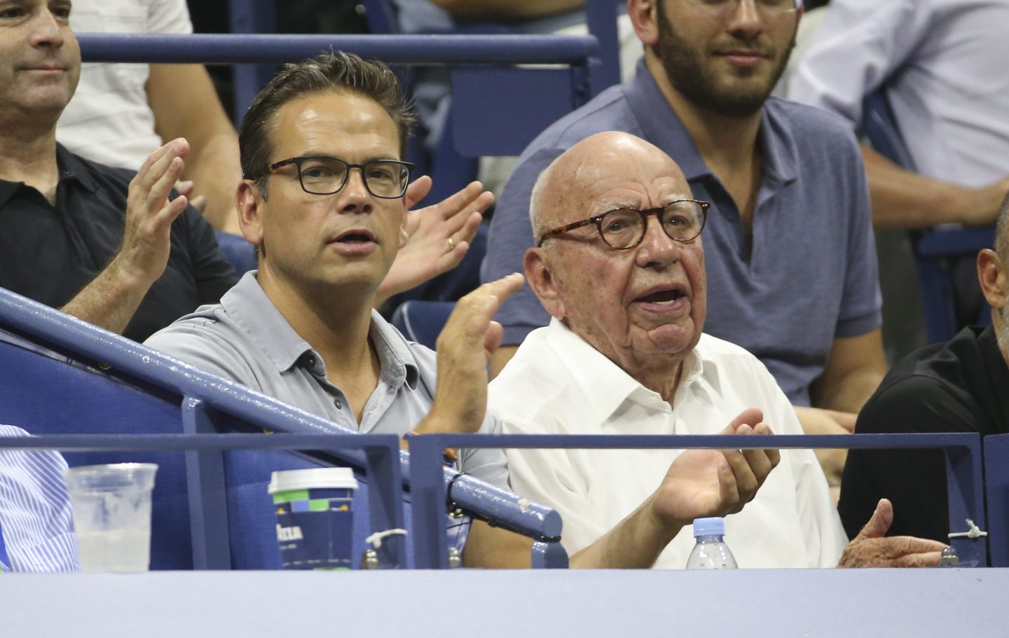 Lachlan Murdoch and Rupert Murdoch clap