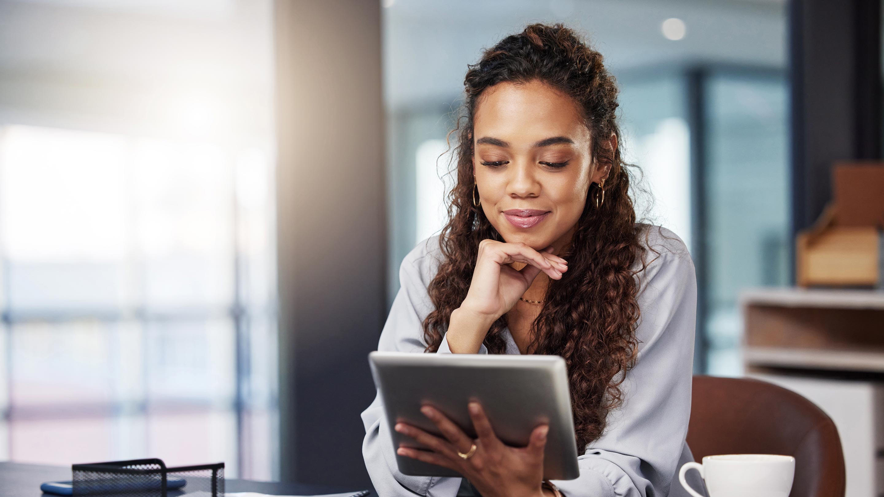 Woman looking down at a tablet