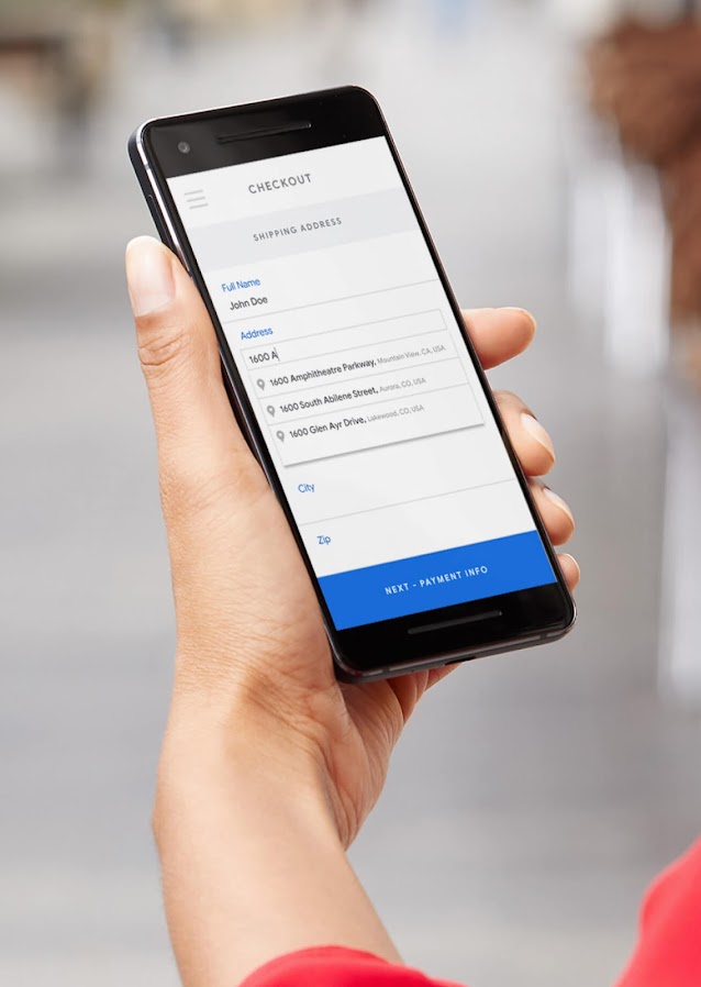 Hand holding phone displaying a checkout screen.