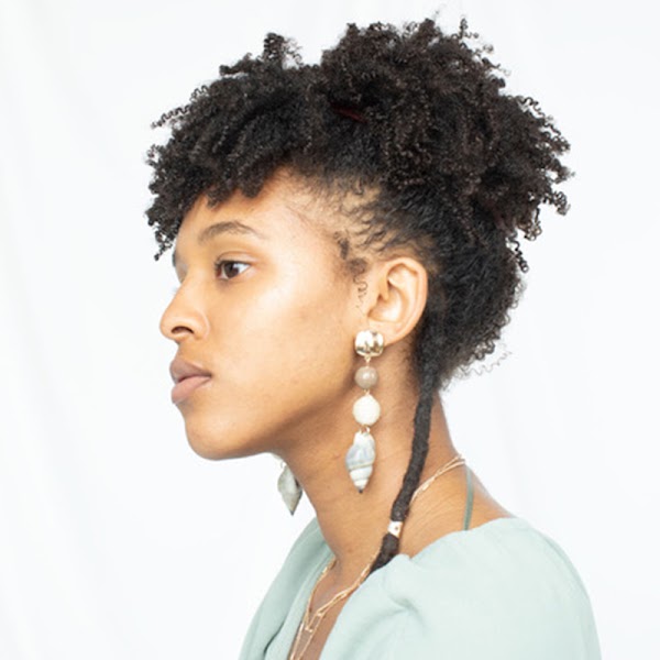 Side profile of artist wearing a light top.