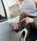 man-breaking-into-car-door