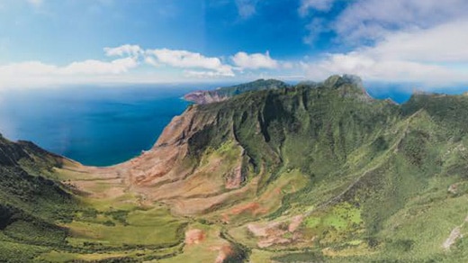 Jagged island mountains and distant ocean view